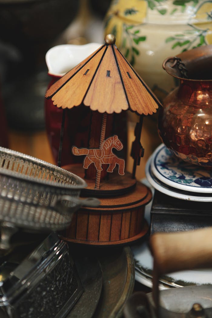 services-img A detailed view of a vintage wooden carousel music box among eclectic antique decorations.